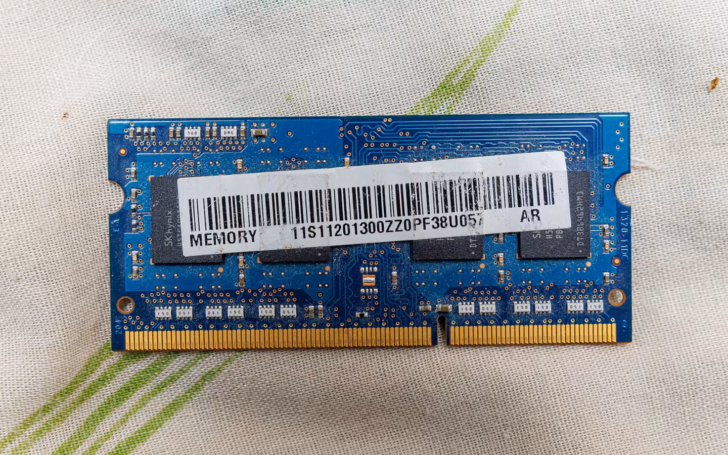 A blue SK Hynix memory module with a barcode on patterned fabric