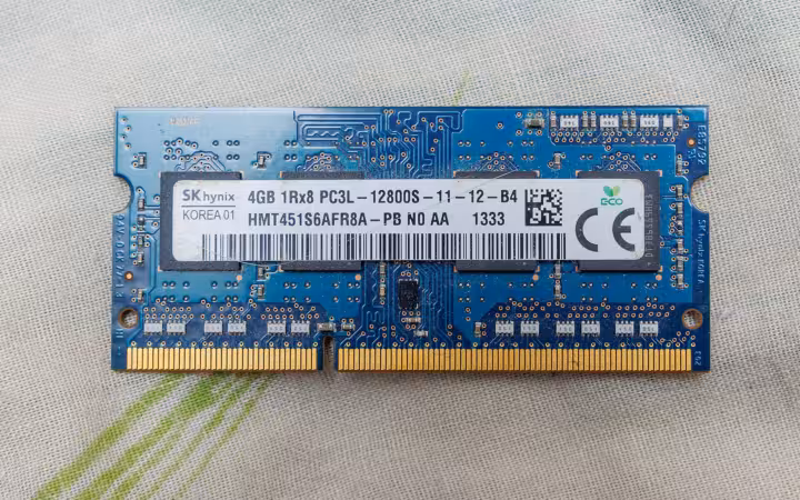 A blue SK Hynix memory module on a pale textured surface.