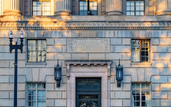 Sunlit facade and entrance of the Herbert C. Hoover Building in Washington, D.C.