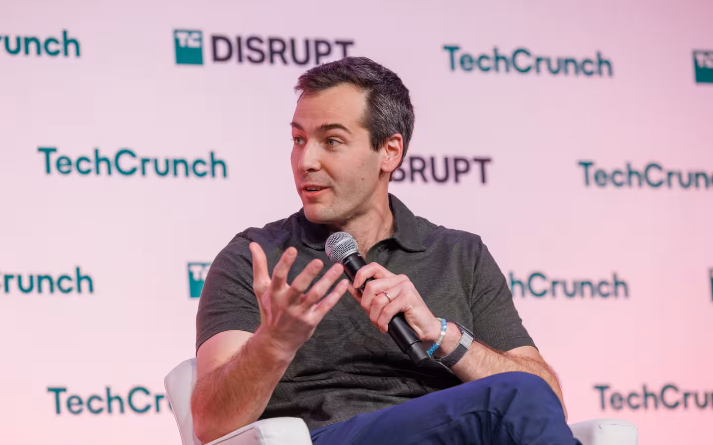 Suno CEO Michael Shulman speaks into a microphone at TechCrunch Disrupt.