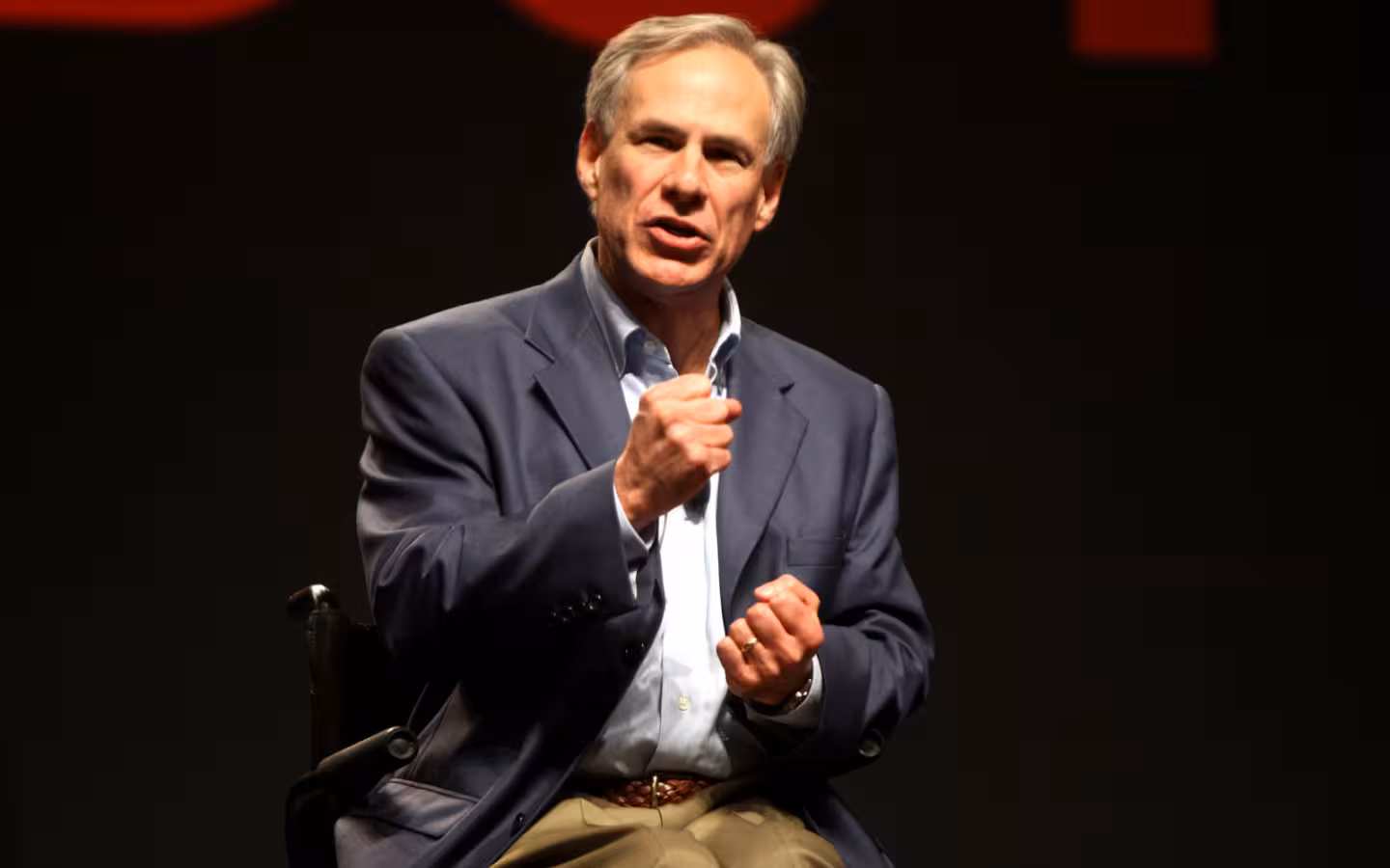 Greg Abbott gestures while speaking onstage at FreePac in Phoenix, Arizona.