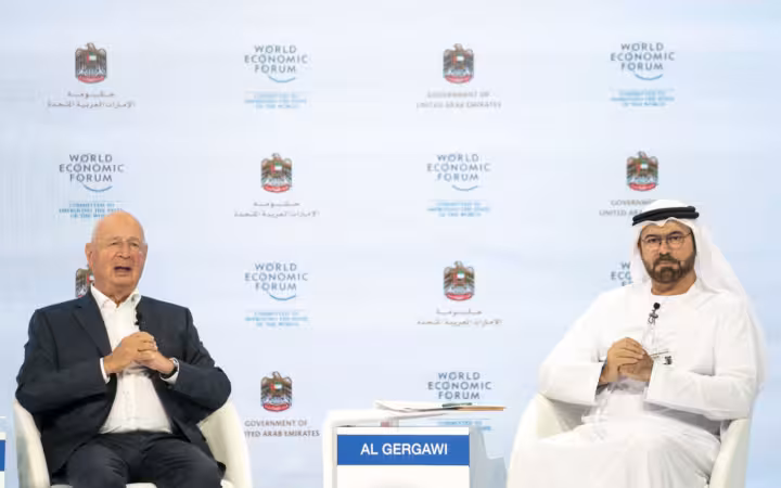 Mohammad Al Gergawi and Klaus Schwab seated before a World Economic Forum backdrop